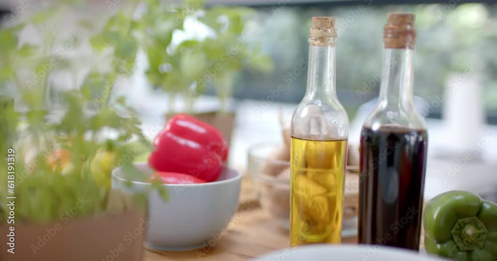 Close up of vegetables and oils in kitchen, slow motion Close up of vegetables and oils in kitchen, slow motion