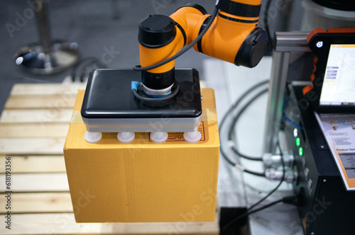 Robot is working by pick the box to packing in manufacturing factory concept