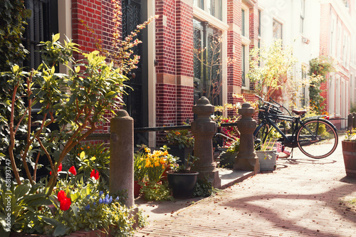 Old architecture in Amsterdam, Netherlands. Beautiful street with flowers