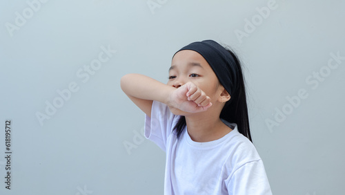 Bilde på lerret adorable young girl smelling her hand or covering mouth and nose while coughing flu
