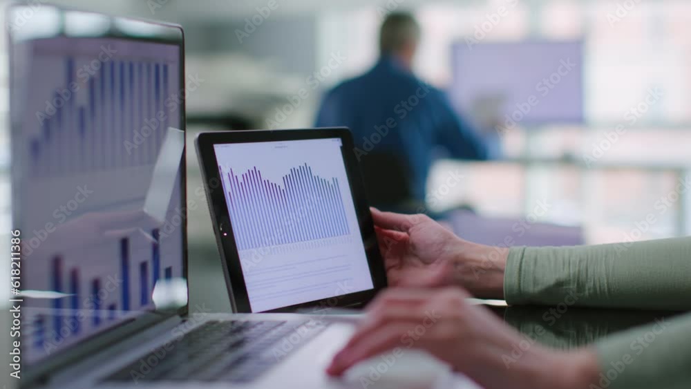 Close up of financial analyst study graphs and charts on laptop and digital tablet Close up of financial analyst study graphs and charts on laptop and digital tablet