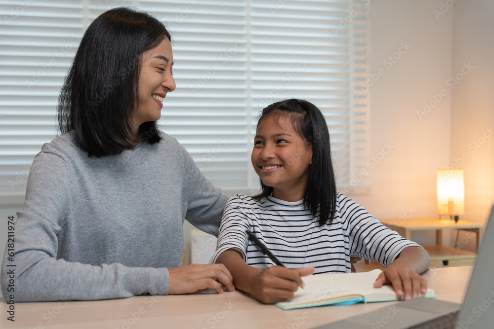 Mother teaching lesson for daughter. Asian young little girl learn at home. Do homework with kind mother help, encourage for exam.. Girl happy Homeschool. Mom advice education together. Mother teaching lesson for daughter. Asian young little girl learn at home. Do homework with kind mother help, encourage for exam.. Girl happy Homeschool. Mom advice education together.