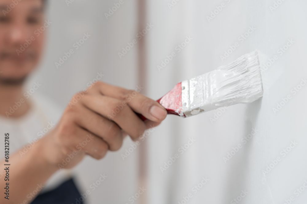 painter man, brush in hand for products to restore and paint the wall, indoor the building site of a house, wall during painting, renovation, painting, contractor, Architect, construction worker painter man, brush in hand for products to restore and paint the wall, indoor the building site of a house, wall during painting, renovation, painting, contractor, Architect, construction worker