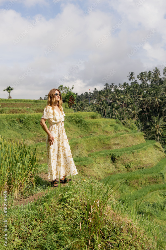 Young woman looking at beautiful tegallalang rice terrace in Bali, Indonesia
