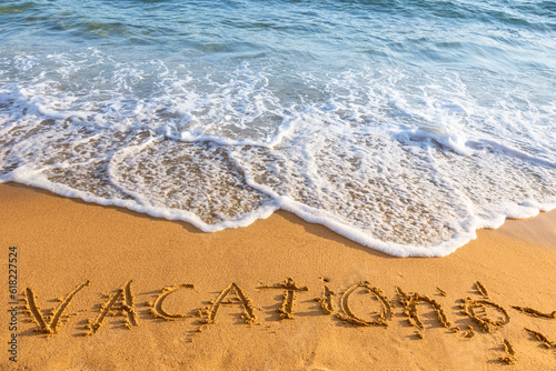 Vacation inscription on sandy beach