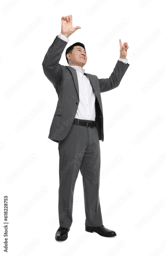 Businessman in suit posing on white background, low angle view Businessman in suit posing on white background, low angle view