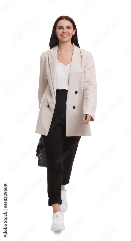 Beautiful businesswoman in suit with briefcase walking on white background Beautiful businesswoman in suit with briefcase walking on white background