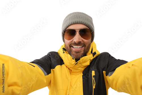 Smiling man in hat and sunglasses taking selfie on white background © New Africa