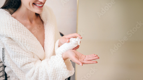 Принти на полотні smiling female applying organic moisturizer gel, closeup