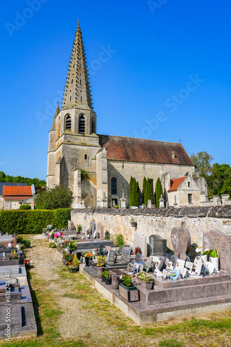 Church Saint André of Septmonts in Aisne, Picardie, France - Gothic flamboyant religious building with a bell tower lined with hooks and crowned with a stone spire