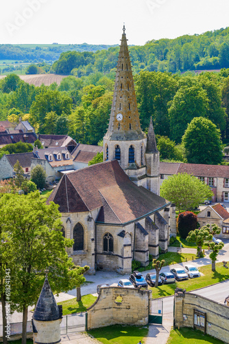 Church Saint André of Septmonts in Aisne, Picardie, France - Gothic flamboyant religious building with a bell tower lined with hooks and crowned with a stone spire