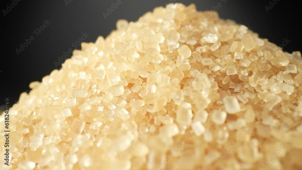 A macro video showcases the texture of brown sugar using a probe lens. The close-up footage reveals its rich golden-brown color, granular structure, and sparkling crystals. Sugar background
A macro video showcases the texture of brown sugar using a probe lens. The close-up footage reveals its rich golden-brown color, granular structure, and sparkling crystals. Sugar background