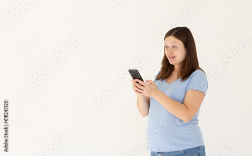 Portrait of attractive focused cheerful pregnant girl using device app chatting isolated over white color background