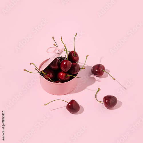A can full of cherries, creative aesthetic fruit layout, romantic pink style. 