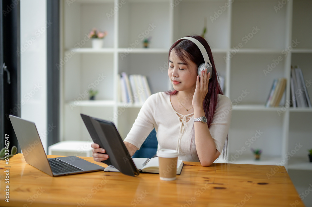 Portrait of teenage happy girl using a digital tablet and wearing headphones, study online via video conferencing. Relaxing with music. Portrait of teenage happy girl using a digital tablet and wearing headphones, study online via video conferencing. Relaxing with music.