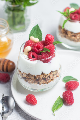 Granola with yogurt and raspberries in a glass