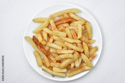 French fries on a white plate and sauce. Delicious breakfast of fried potatoes.