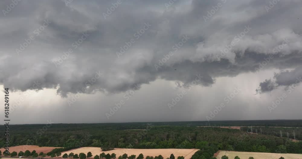 Drone flight over land with fast moving storm clouds just before a thunderstorm Drone flight over land with fast moving storm clouds just before a thunderstorm