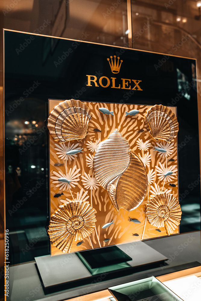 Vertical advertising of Rolex watches in the window of a watch store in famous shopping mall