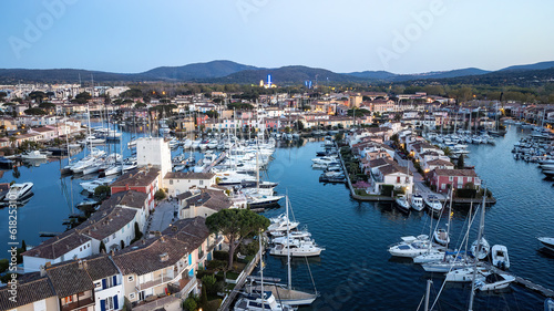 Port Grimaud harbor in France in springtime with yachts and sailboats and Mediterranean Sea in the evening  drone shot  Cote d Azur