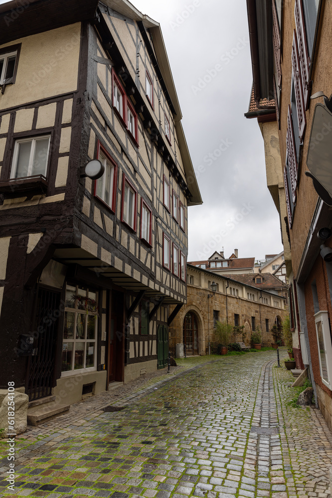 Side street of Esslingen on a rainy spring day with half-timbered houses and cobblestones
