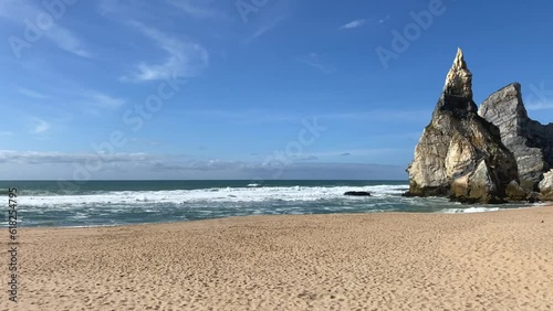 An empty wild sandy beach, Atlantic Ocean seascape, sea waves, beautiful cloudscape, dramatic landscape, travel content, Lisbon, Portugal