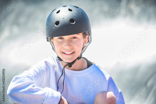 child girl playing skate or skateboard at parking to wearing safety helmet © Louis-Photo