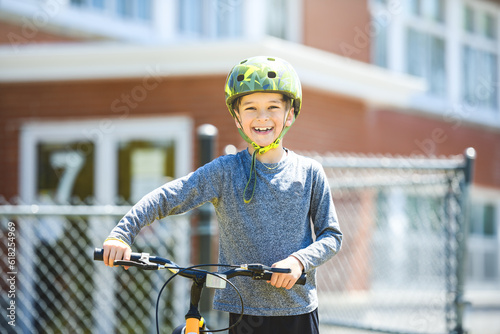 child having fun outdoors driving bike for children on playground