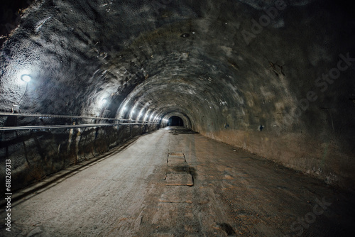 Dark large tunnel at old underground bunker