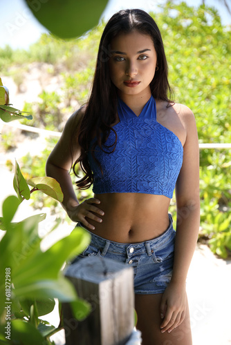 Latina girl at the beach in blue with trees