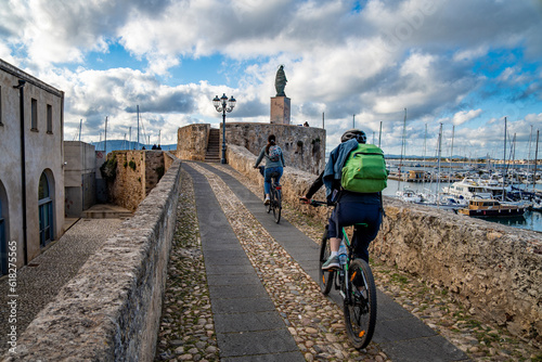 Two cyclists in the marina of Alghero