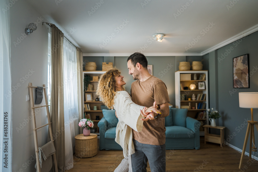 Happy couple adult caucasian man woman husband and wife dance at home - obrazy, fototapety, plakaty 