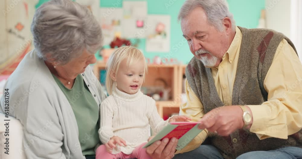 Grandparents, kid and reading with teaching for education with support or love in childhood. Learning, grandmother and senior male with books for girl or knowledge at family home or conversation. Grandparents, kid and reading with teaching for education with support or love in childhood. Learning, grandmother and senior male with books for girl or knowledge at family home or conversation.