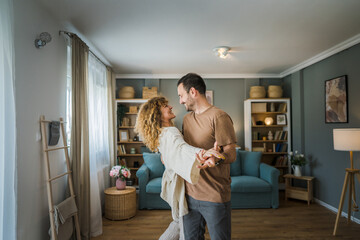 Happy couple adult caucasian man woman husband and wife dance at home