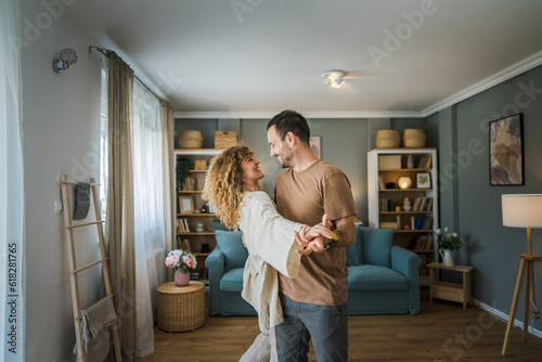 Happy couple adult caucasian man woman husband and wife dance at home photo