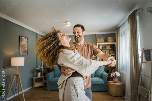 Happy couple adult caucasian man woman husband and wife dance at home