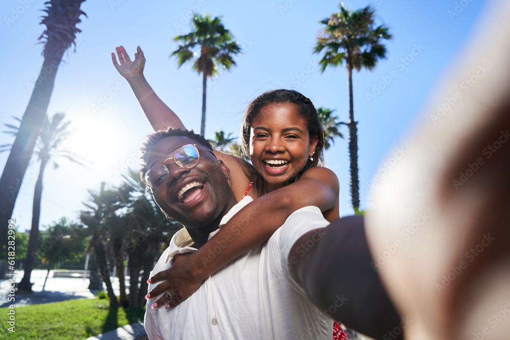 Cheerful selfie of a young African American couple on their summer vacation on an island.