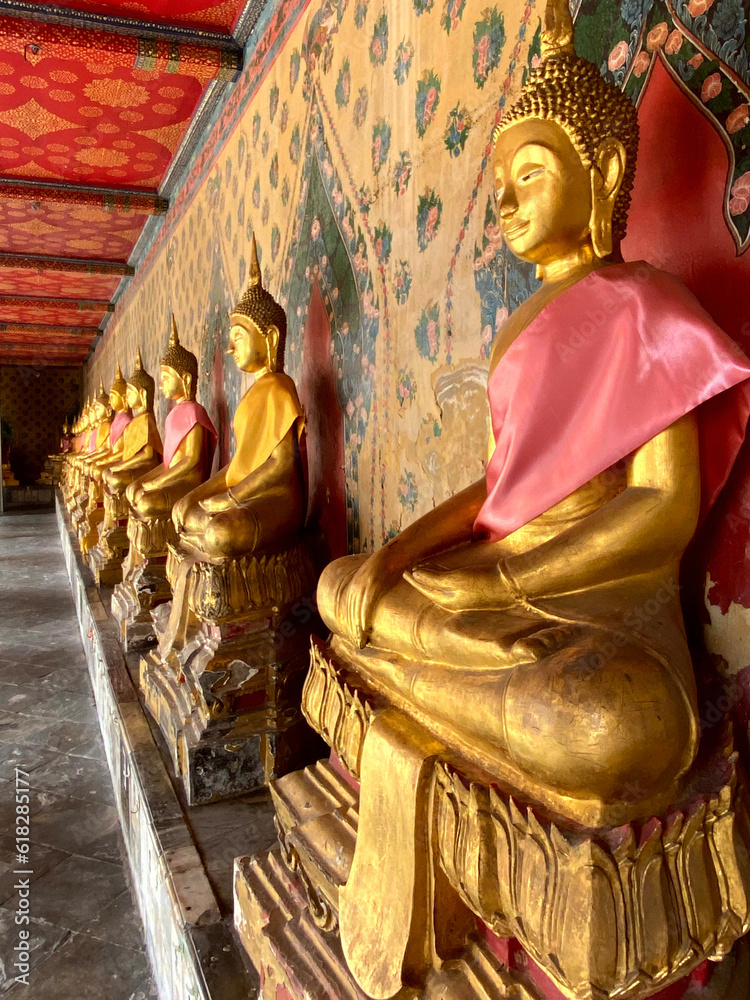 Gallery with old vessels of the seated Buddha in the Buddhist temple Wat Arun. Bangkok, Thailand