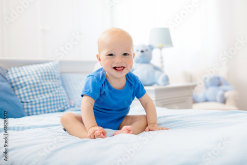 Little baby boy on white bed