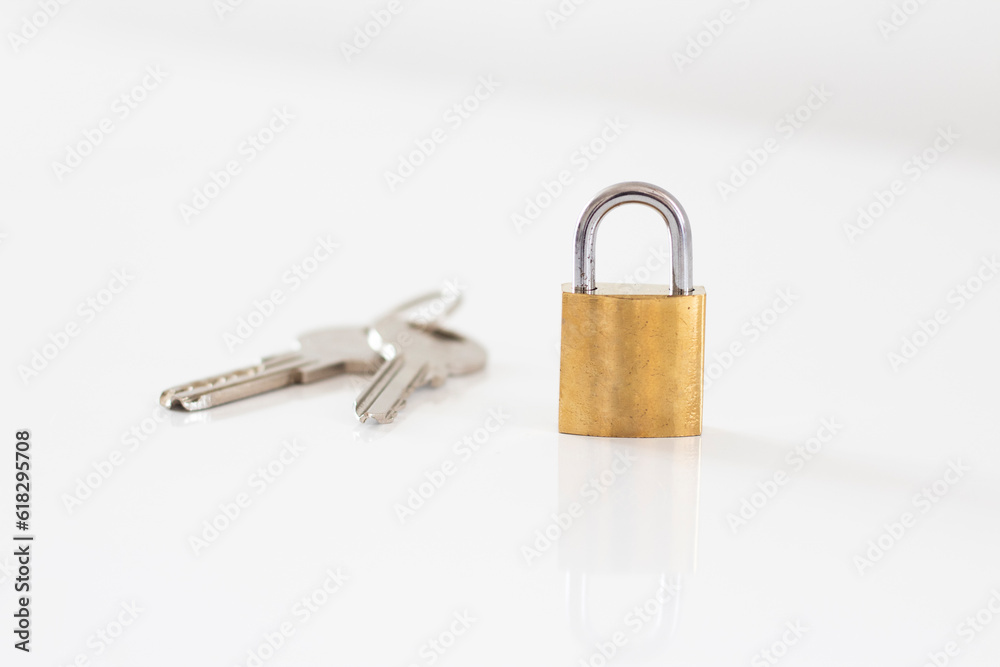 Gold locked padlock and keys on white background. Home security concept Gold locked padlock and keys on white background. Home security concept
