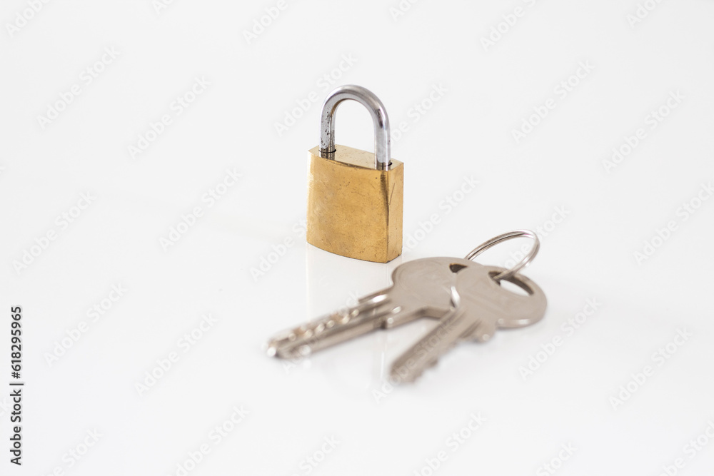 Gold locked padlock and keys on white background. Home security concept Gold locked padlock and keys on white background. Home security concept
