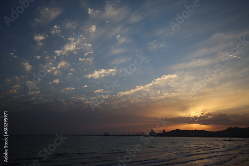 Sea sunset gradient background on cloudy sky and sun behind cloud