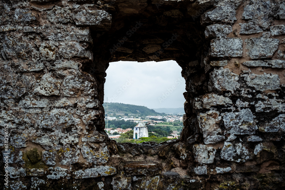 Window hole in the walls of a medieval castle in a rural town of Europe