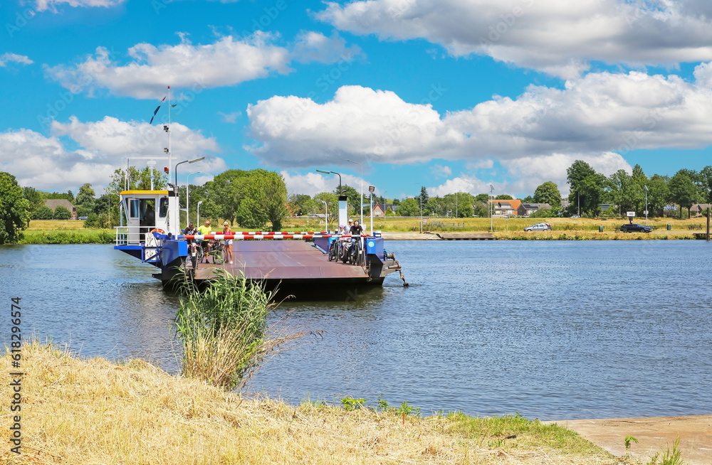 custom made wallpaper toronto digitalAfferden - Sambeek, Netherlands - Juine 9. 2023: Passenger, car and bike ferry crossing dutch river Maas