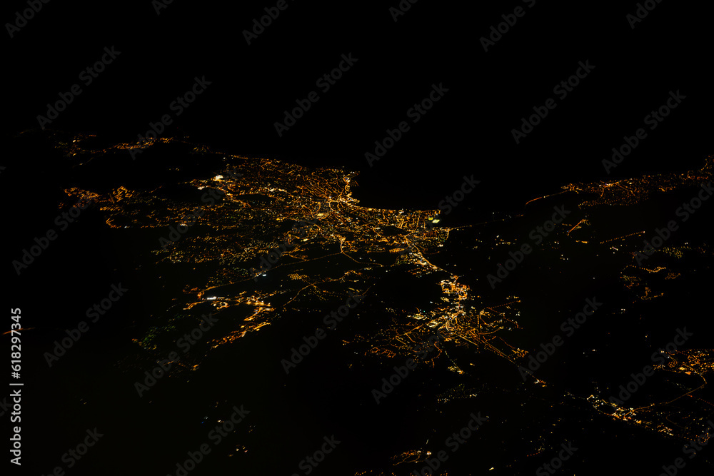 Nighttime aerial view of illuminated city Saint Raphael and coastal France from the sky