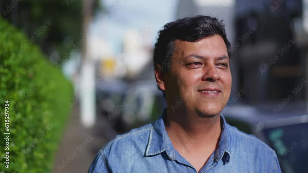 Sunlit Face of Contemplative Brazilian Man Walking in City Street - Close-Up Tracking Shot, close-up face with happy expression smiling Sunlit Face of Contemplative Brazilian Man Walking in City Street - Close-Up Tracking Shot, close-up face with happy expression smiling