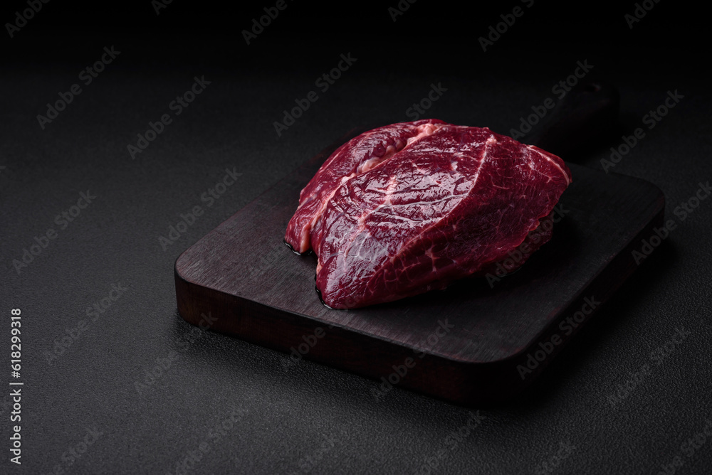 Fresh raw beef steak with salt, spices and herbs