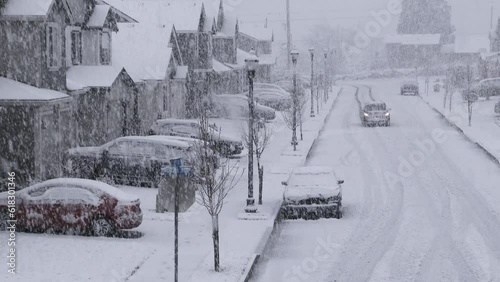 Person Driving Down Snowy Reidential Neighborhood