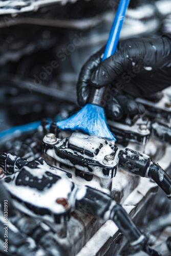 Cleaning car engine with brush