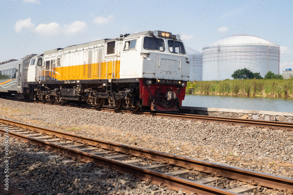 Domestic train pass the rail way when day time with blue sky. Domestic train pass the rail way when day time with blue sky.